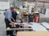 Kevin Hunsicker is Executive Sales Director at Thomas Signs and has been personally involved in this project. Here he is explaining the cutout and construction process for the signs to William R. Gaines Sr. while Canyon Gaines examines the cutouts.<br />