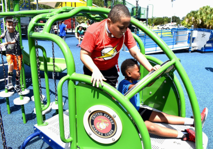 Ben 12, Judah 8, and David Bitner 9 play on a helicopter structure at the new military themed playground at William R. Gaines Jr. Veterans Memorial Park in Port Charlotte, FL